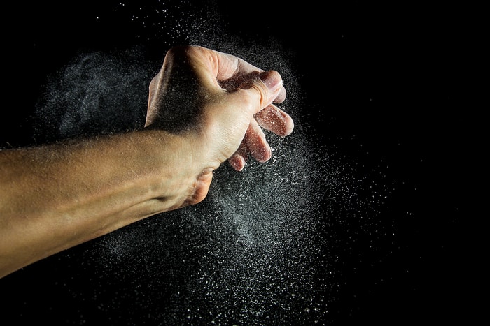 time lapse photography of person's hand with powder