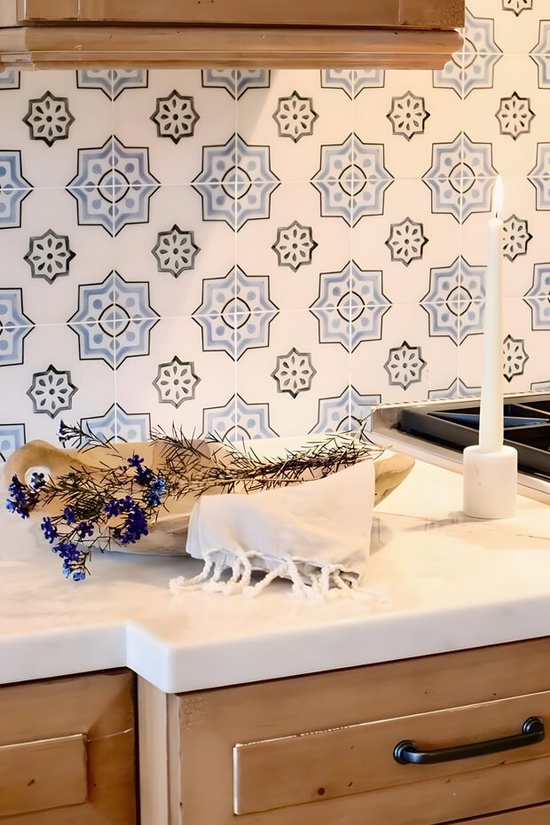 Blue and white geometric ceramic kitchen backsplash tiles with interlocking diamonds pattern