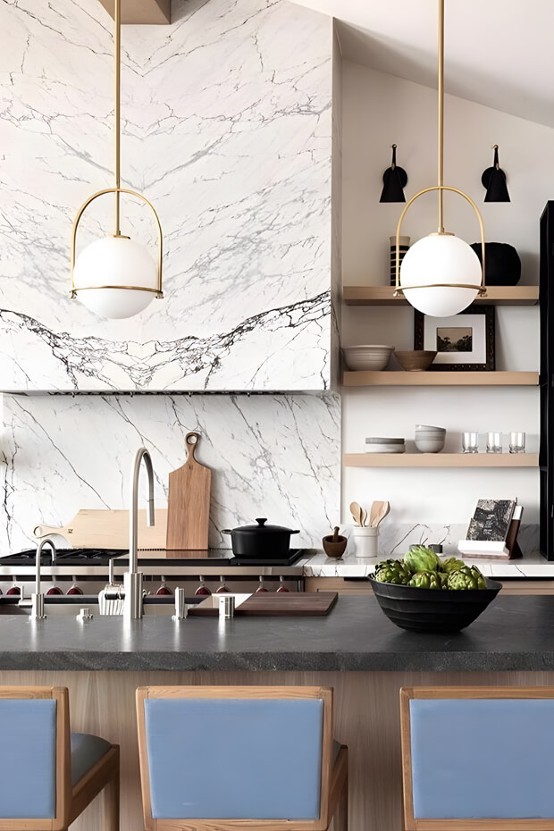 Warm and cozy ambiance provided by three pendant lights above kitchen island