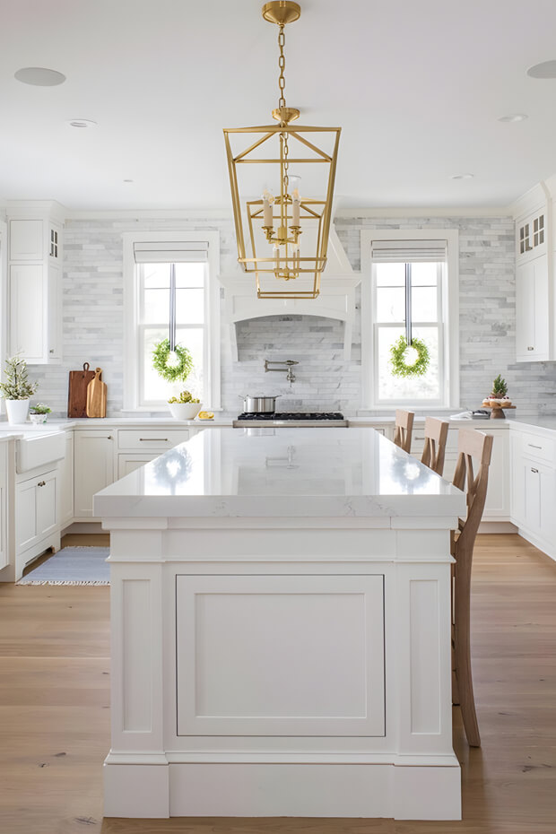 Kitchen with white cabinets and white marble island