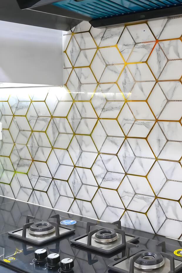 White and gold marble-like hexagonal kitchen backsplash tiles with metallic sheen