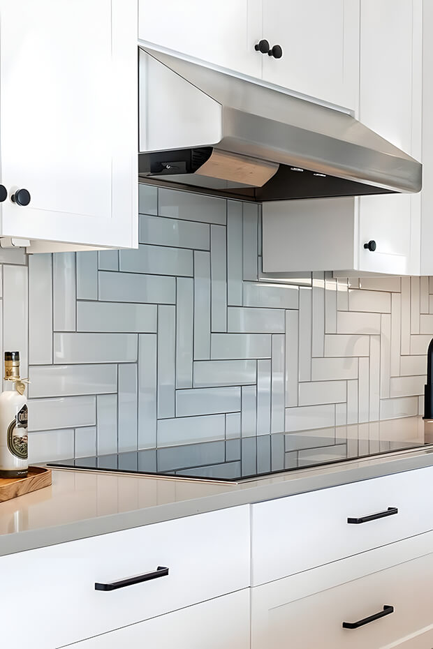 White and gray chevron patterned kitchen backsplash tiles
