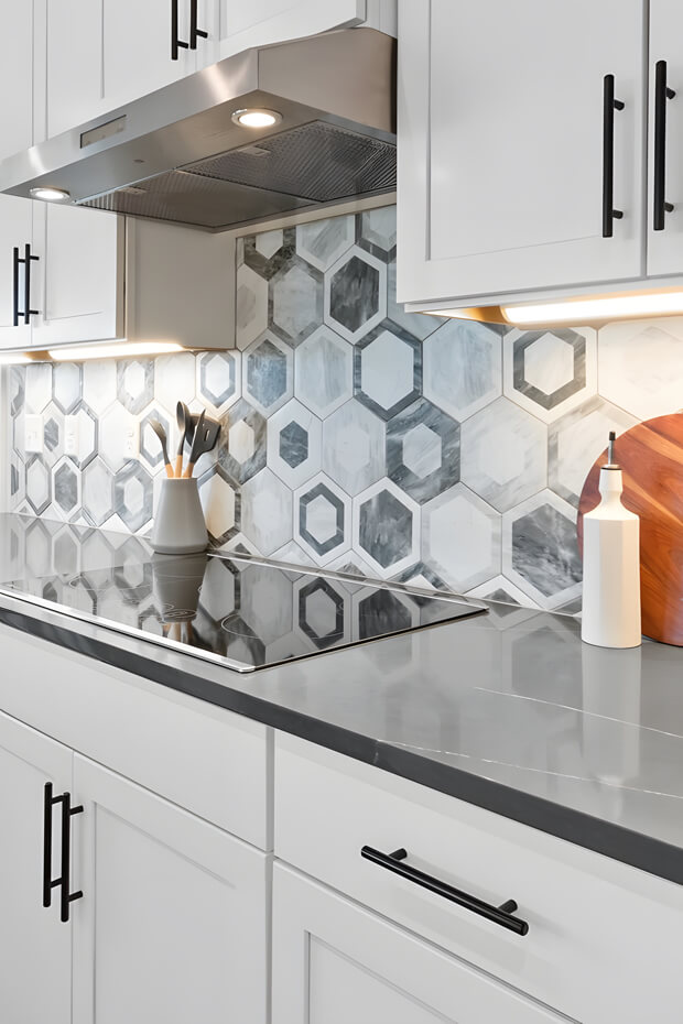 White and grey hexagonal kitchen backsplash tiles with pattern